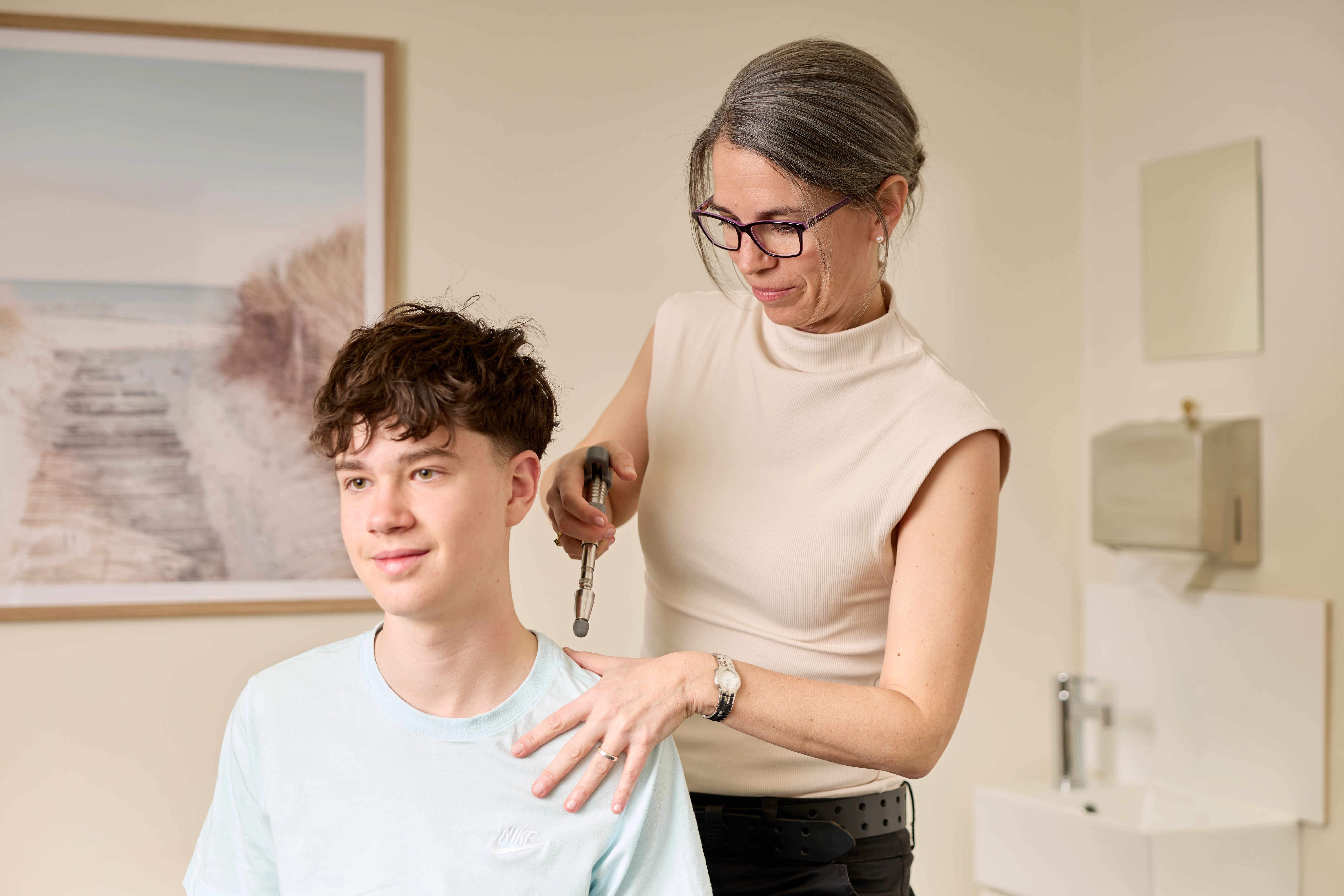 A teenager receiving a shoulder treatment from Dr Adrienne Wilson chiropractor at Norwood Adelaide